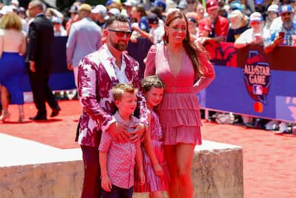 Texas Rangers relief pitcher Kirby Yates stands with his wife Ashlee Rowe and their children...