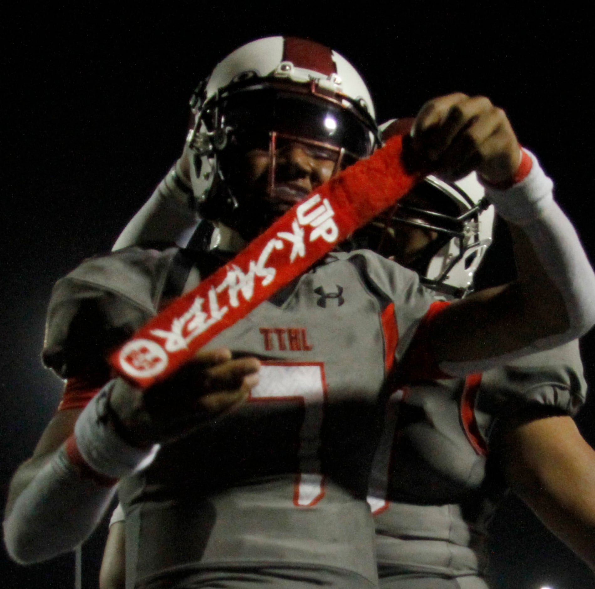 Cedar Hill quarterback Kaidon Salter (7) sports a smile along with a towel which bears his...
