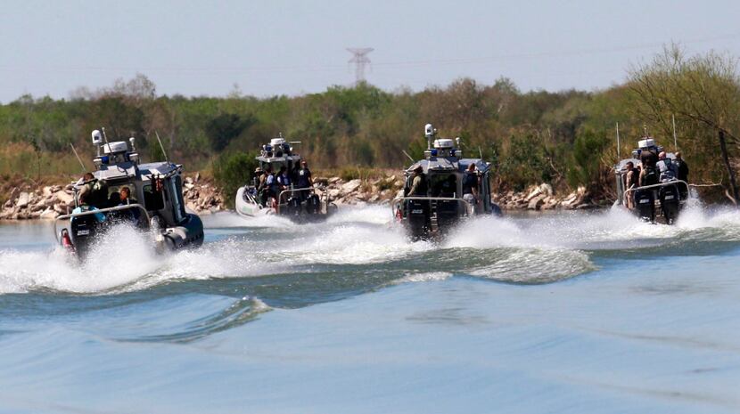 U.S. Customs and Border Protection agents take to the waters of the Rio Grande near Mission,...