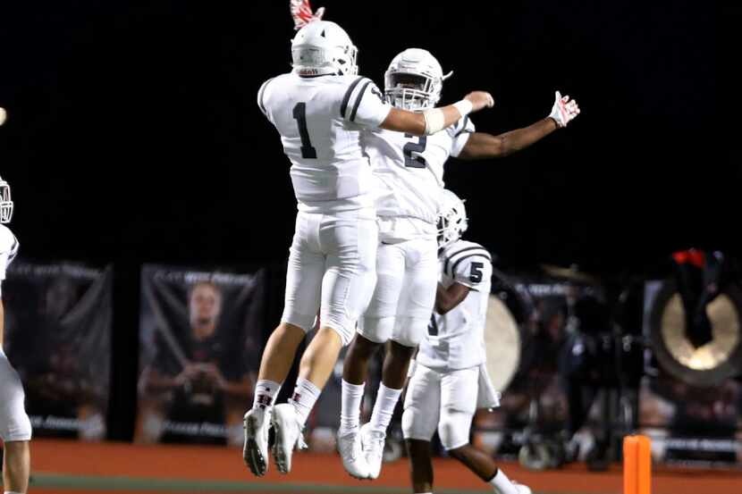 Rockwall Heath's Grant Buckholt (1) and Tanner McCalister (2) celebrate McCalister's after...