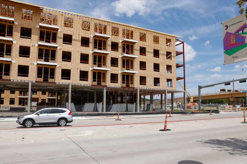 The new Belt & Main apartments and retail building under construction along Main Street in...