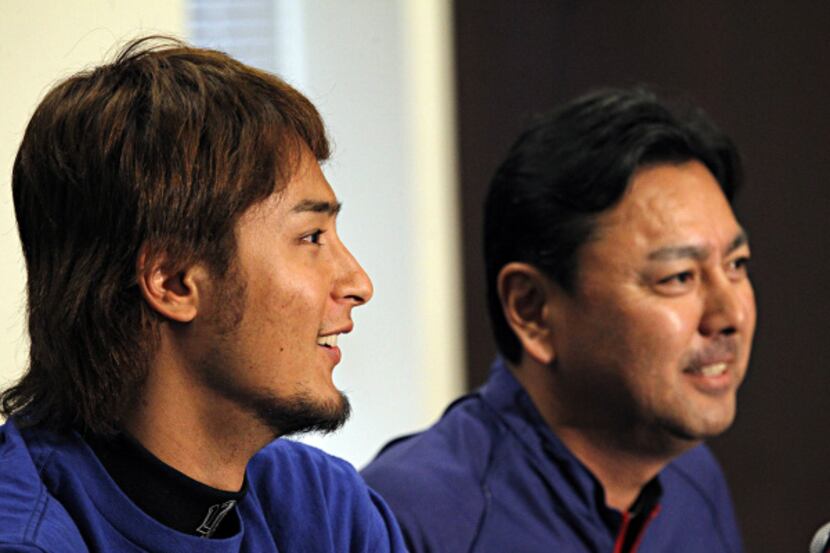 Texas Rangers pitcher Yu Darvish (left) and his translator Joe Furukawa smile as they...