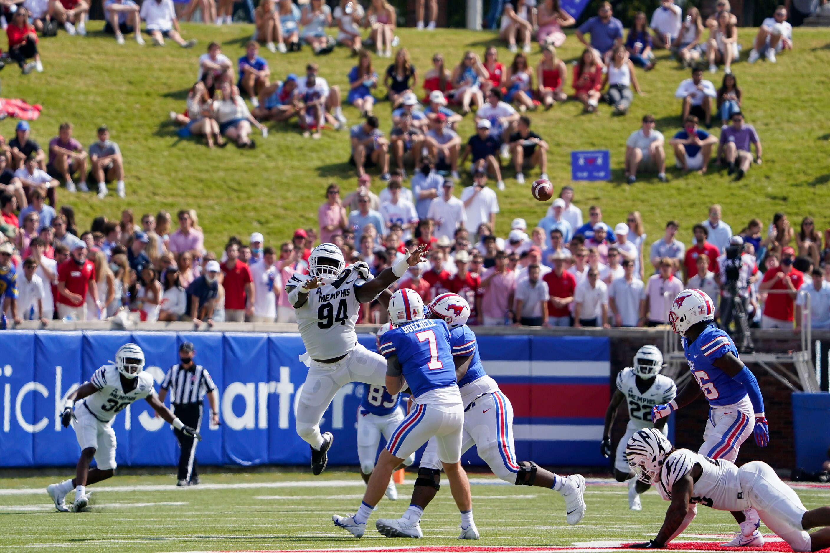 SMU quarterback Shane Buechele (7) gets off a pass under pressure from Memphis defensive...