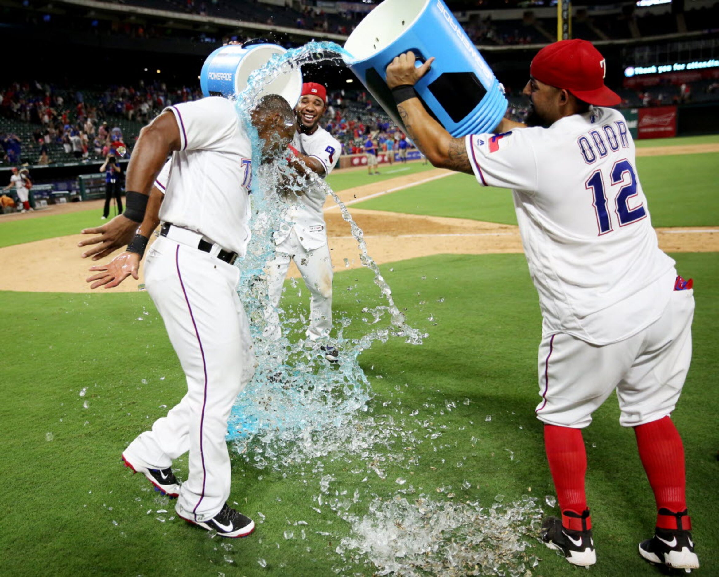 Texas Rangers third baseman Adrian Beltre (29) is doused by second baseman Rougned Odor (12)...