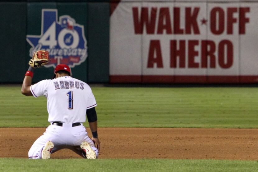 Texas shortstop Elvis Andrus reacts to missing a diving try at a Baltimore run-scoring hit...