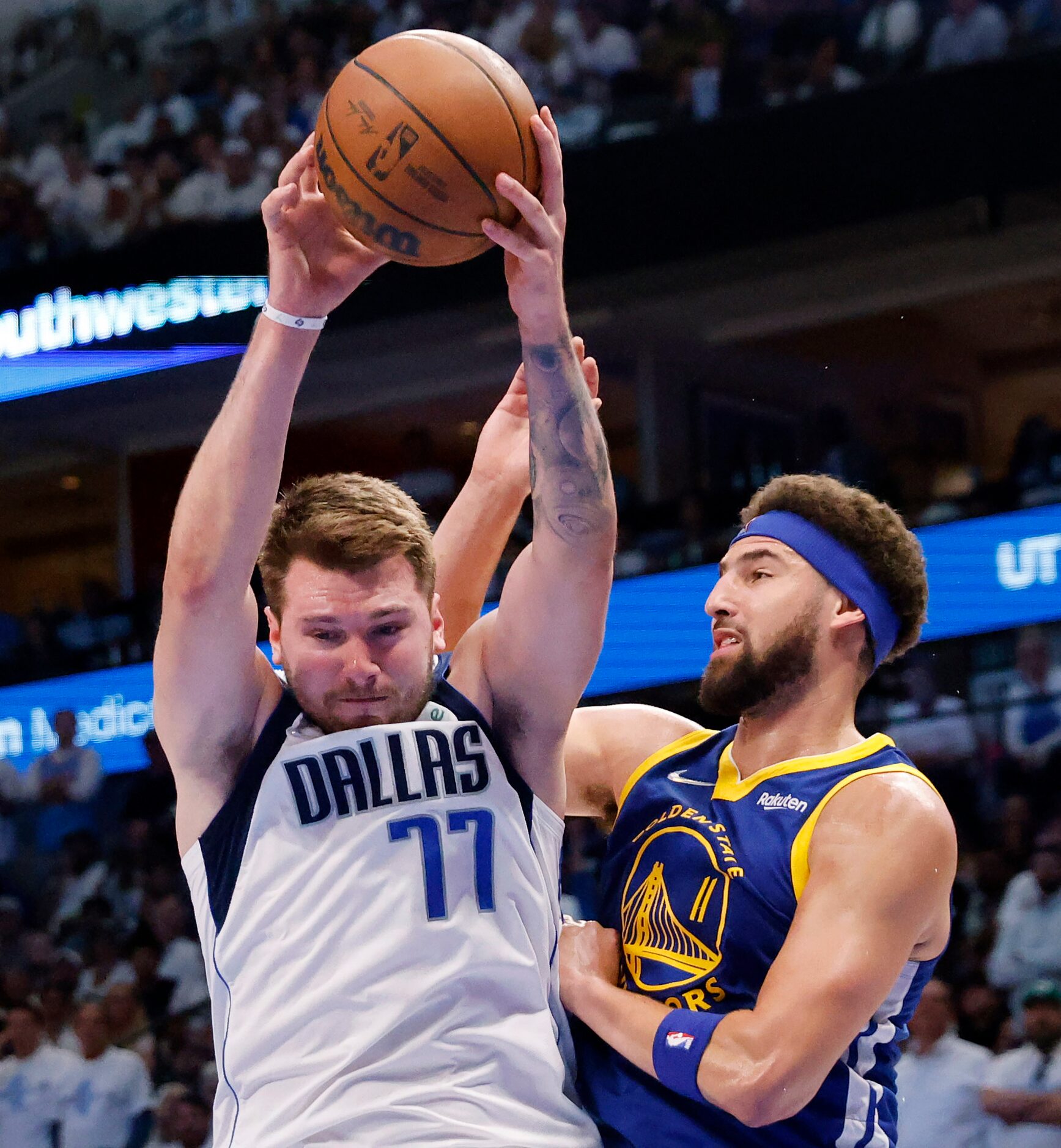 Dallas Mavericks guard Luka Doncic (77) pulls down a defensive rebound against Golden State...