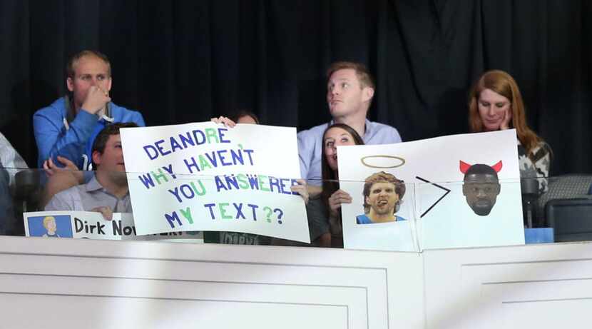 Dallas Mavericks fans hold signs about Los Angeles Clippers center DeAndre Jordan (6) before...