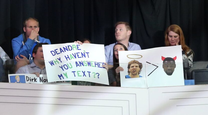 Dallas Mavericks fans hold signs about Los Angeles Clippers center DeAndre Jordan (6) before...