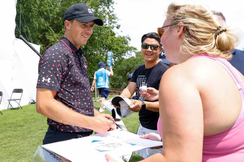 Jordan Spieth smiles as he gives autograph to fans during AT&T Byron Nelson Pro-Am on...