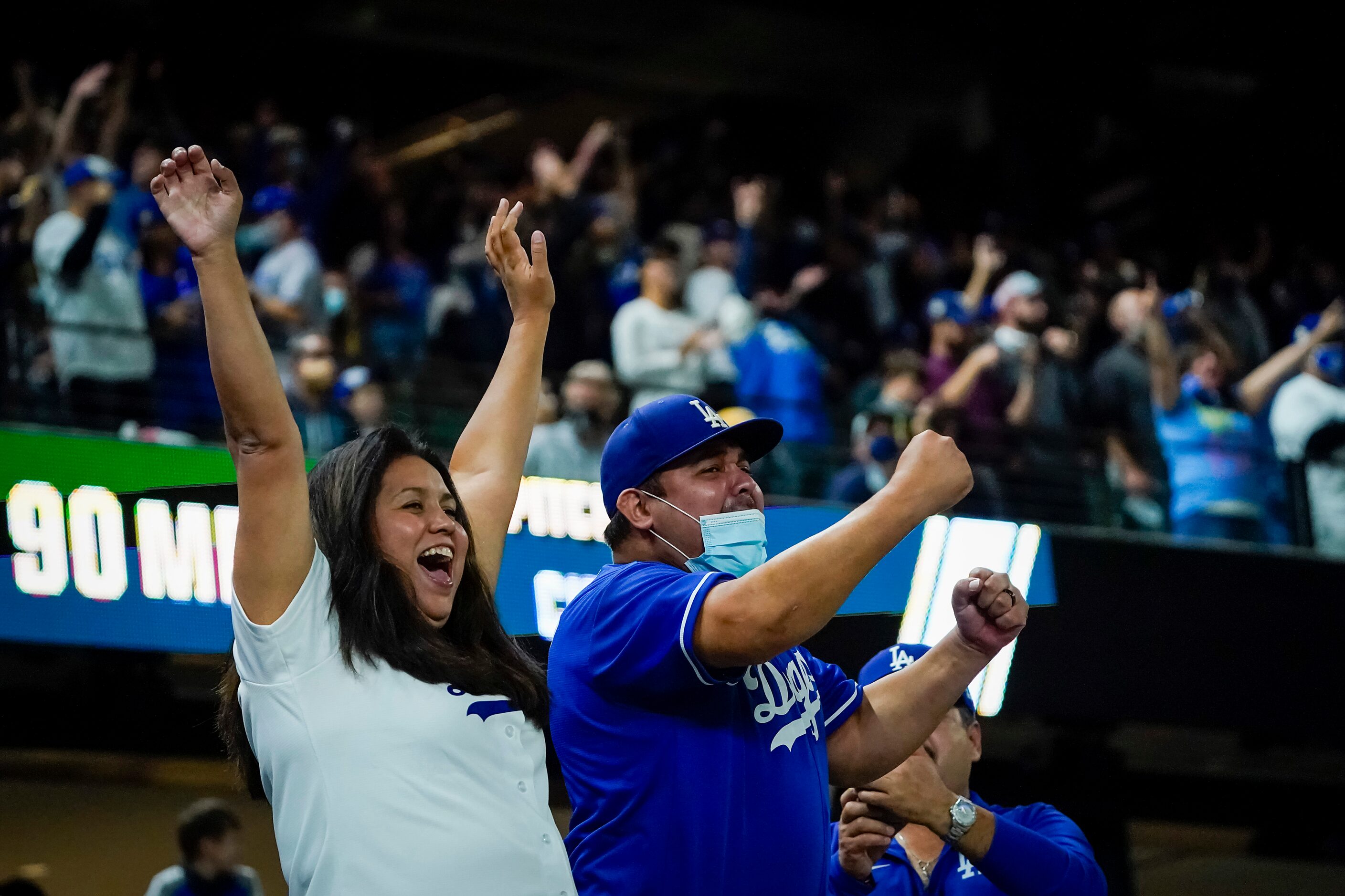 Los Angeles Dodgers fans celebrate the final out of a 6-2 victory over the Tampa Bay Rays in...