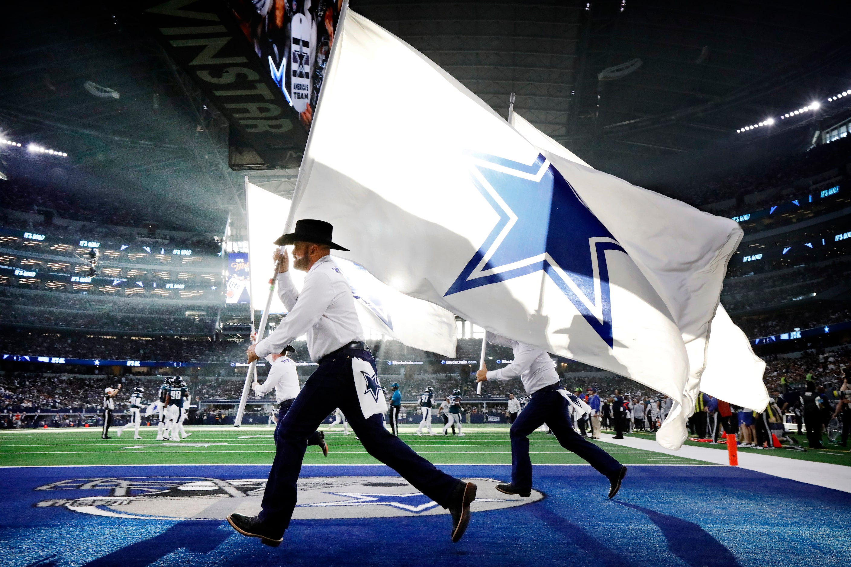 The Dallas Cowboys Flag Team members race across the end zone following a first half score...