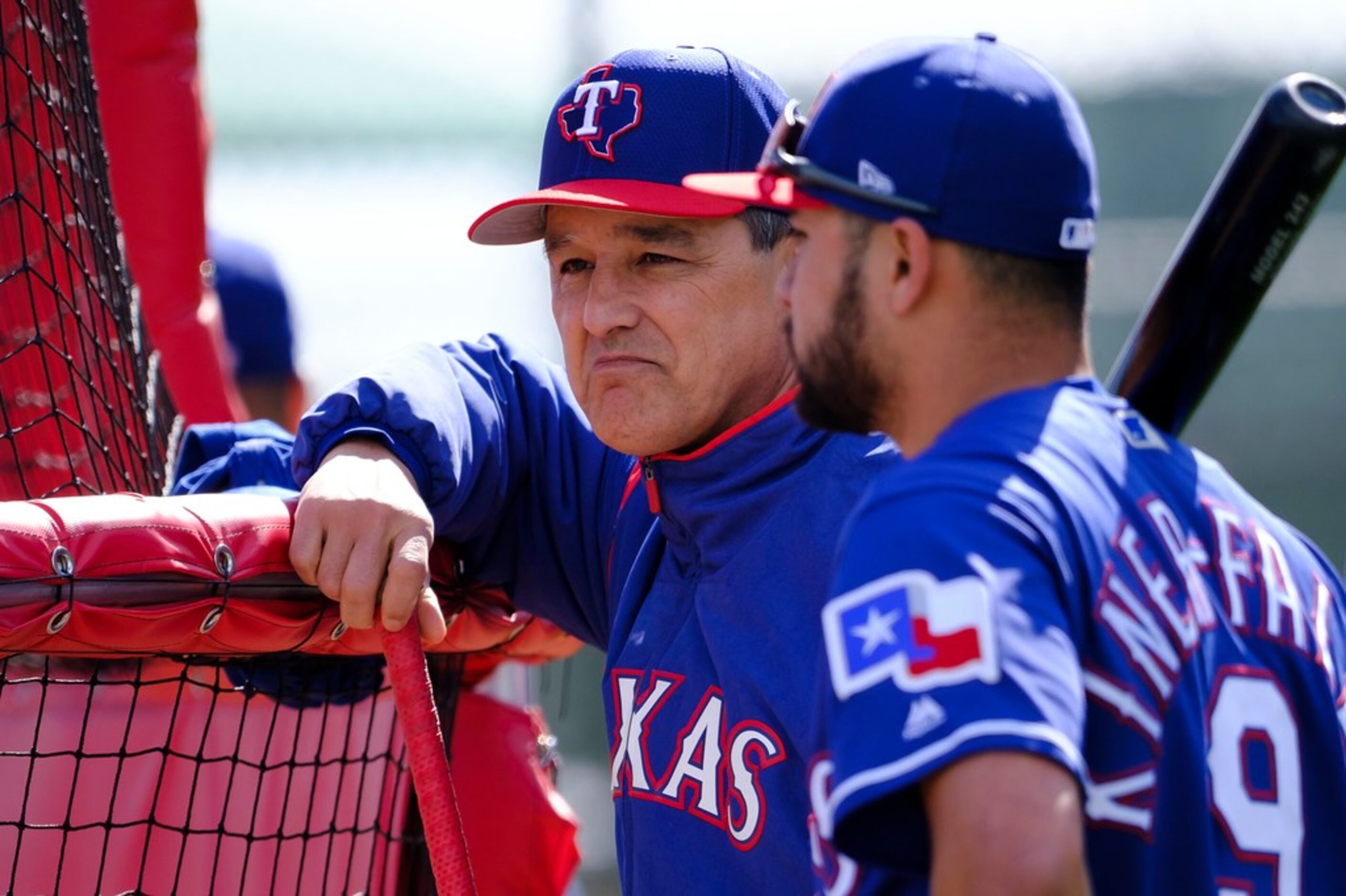 Texas Rangers bench coach Don Wakamatsu talks with catcher Isiah Kiner-Falefa around the...