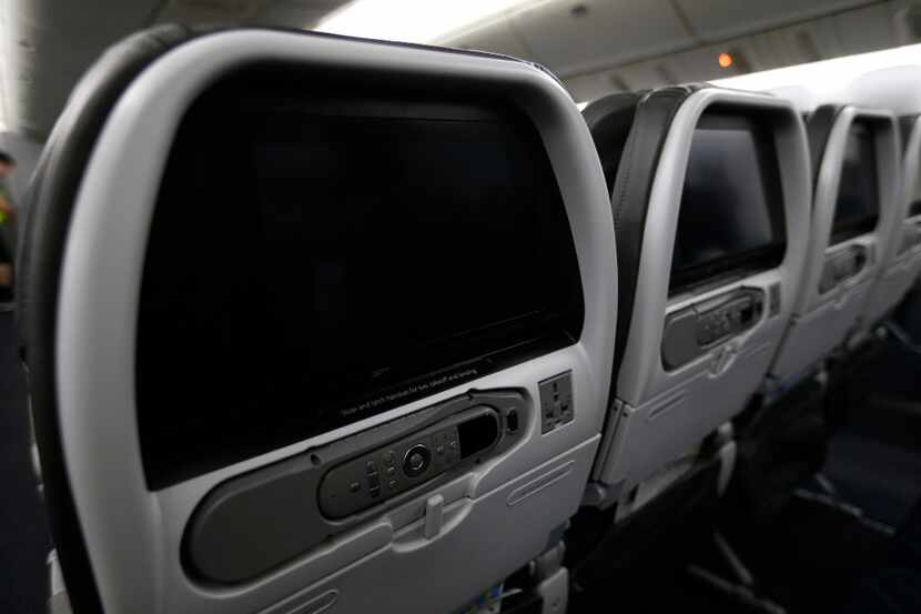 Small monitors are seen on the back of each seats in the cabin area of an American Airlines...
