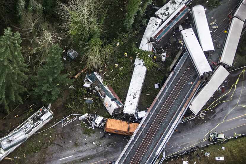 An Amtrak train derailed and fell off of a bridge and onto Interstate 5 south of Seattle on...
