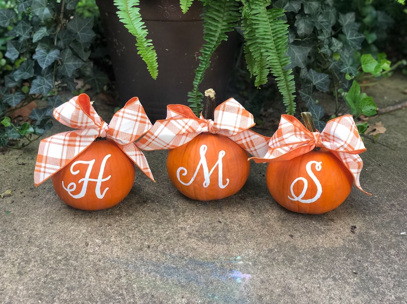 Paint your pumpkins with an initial, family name, or favorite team to personalize your porch.