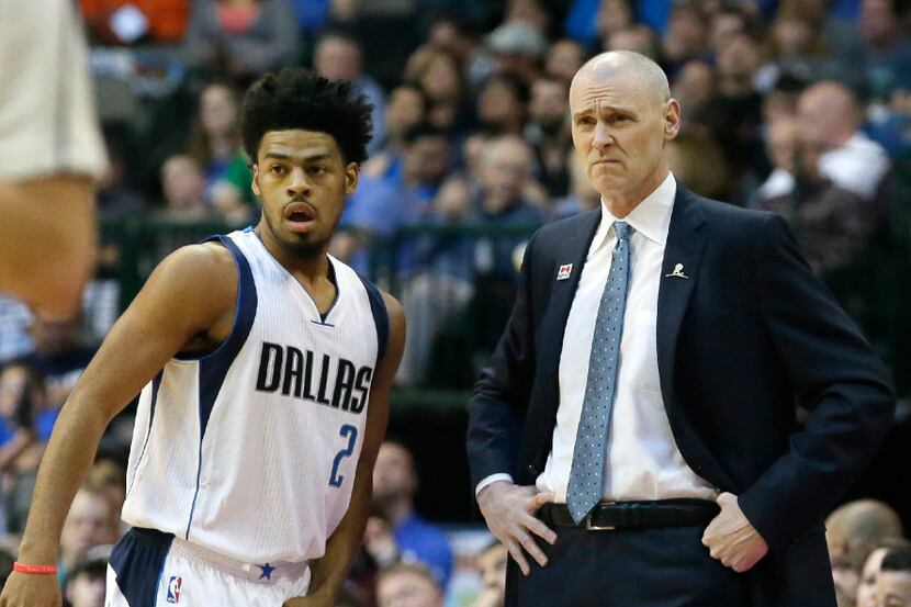 Dallas Mavericks head coach Rick Carlisle and guard Quinn Cook (2) look on from the sideline...