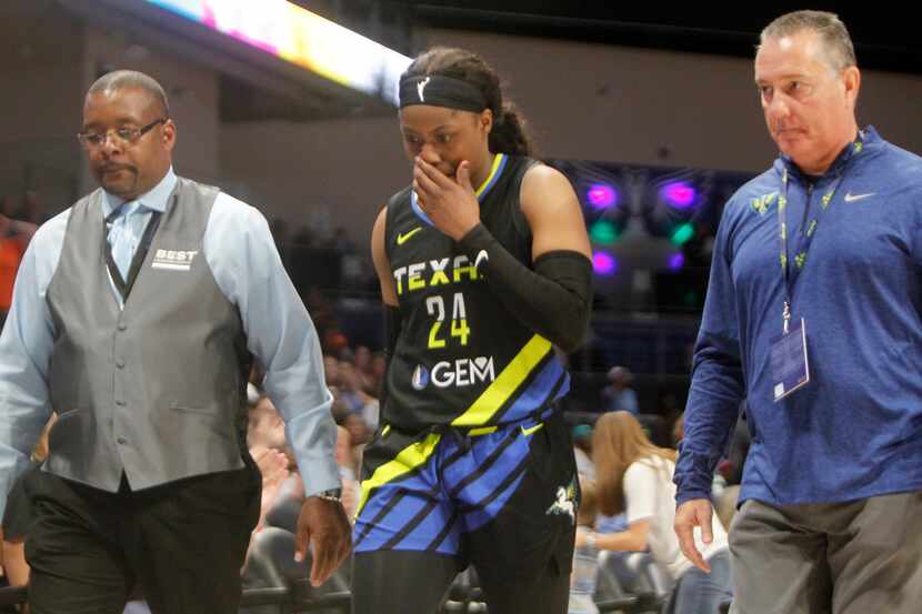 Dallas Wings guard Arike Ogunbowale (24) is escorted from the court after being ejected for...