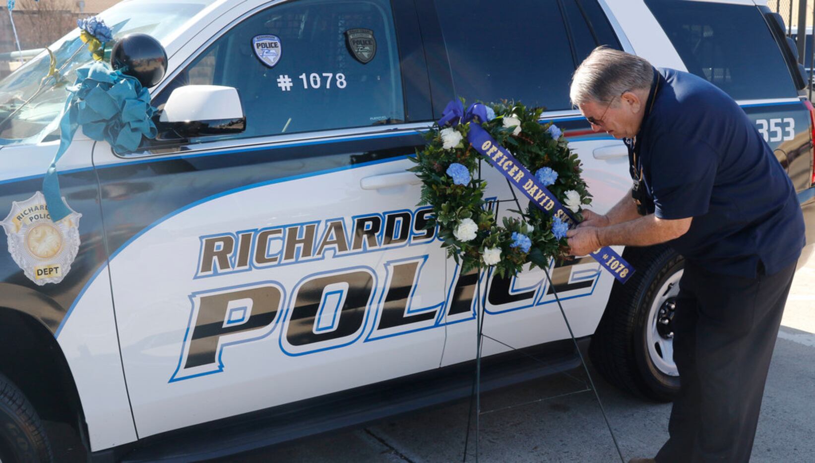 Retired California police officer Larry Powell delivers a wreath to the Richardson, Texas...
