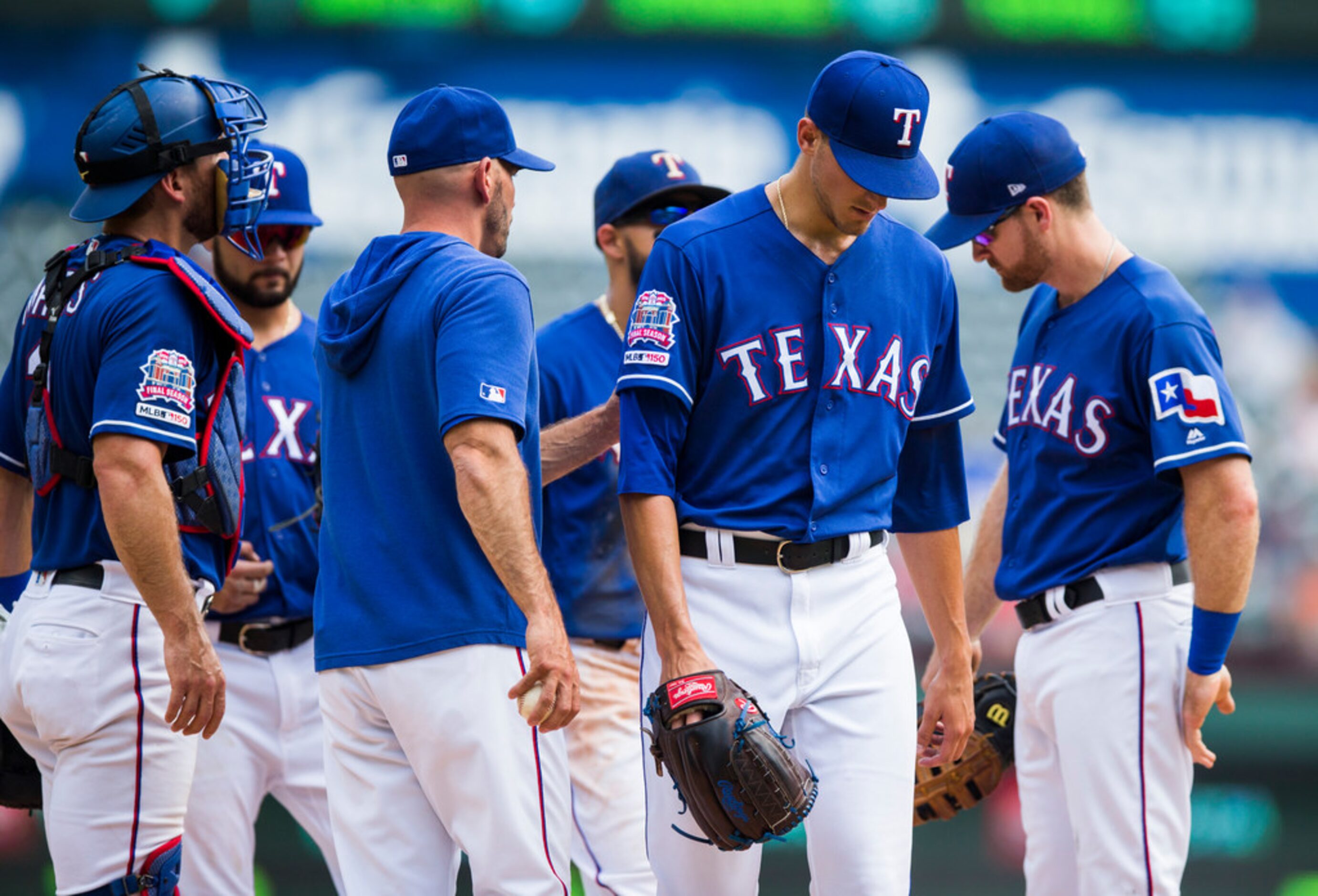 Texas Rangers starting pitcher Brett Martin (59) is taken off the mound during the first...