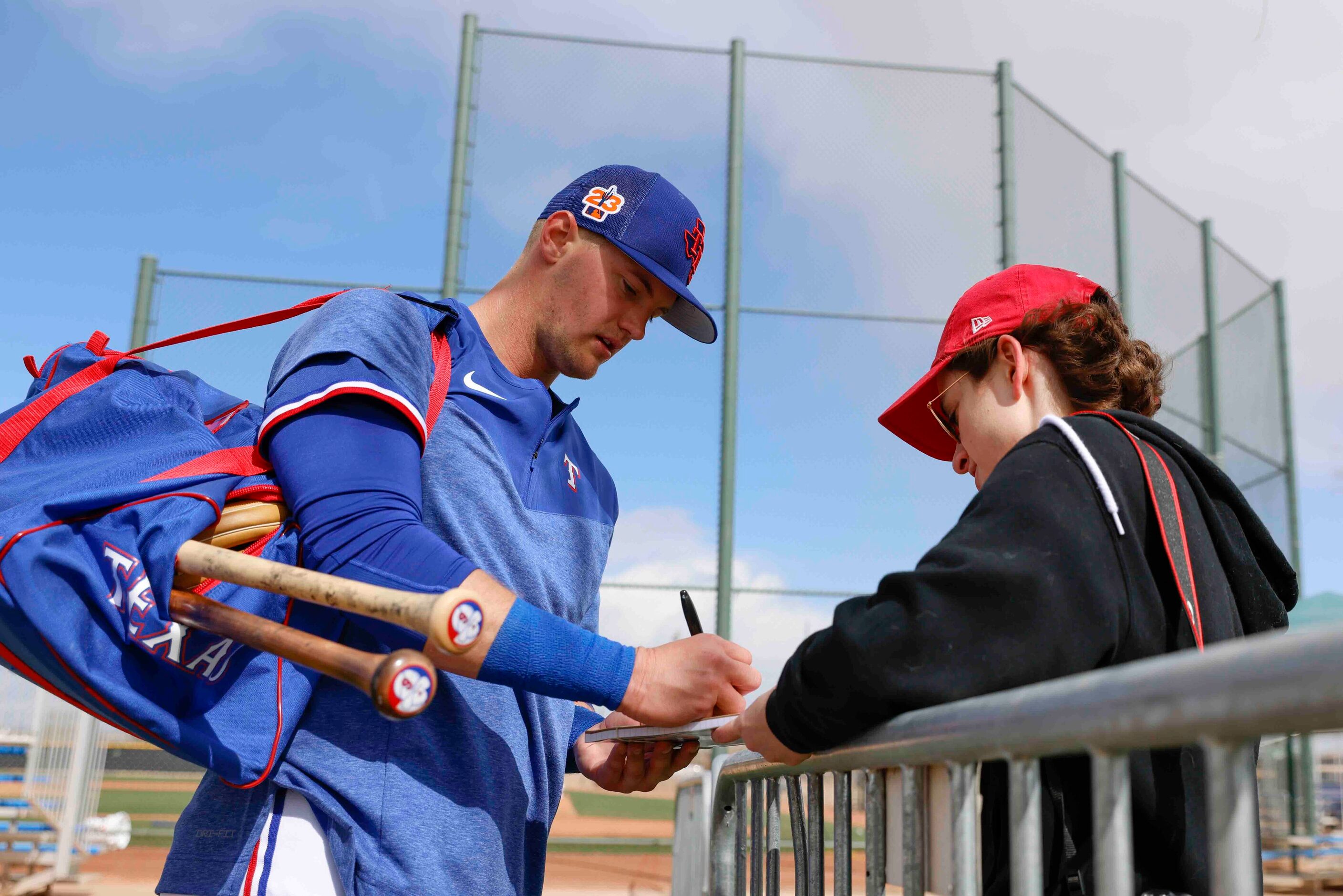 Texas Rangers infielder Josh Jung signs an autograph to Nicole Lukasiewicz, of Peoria after...