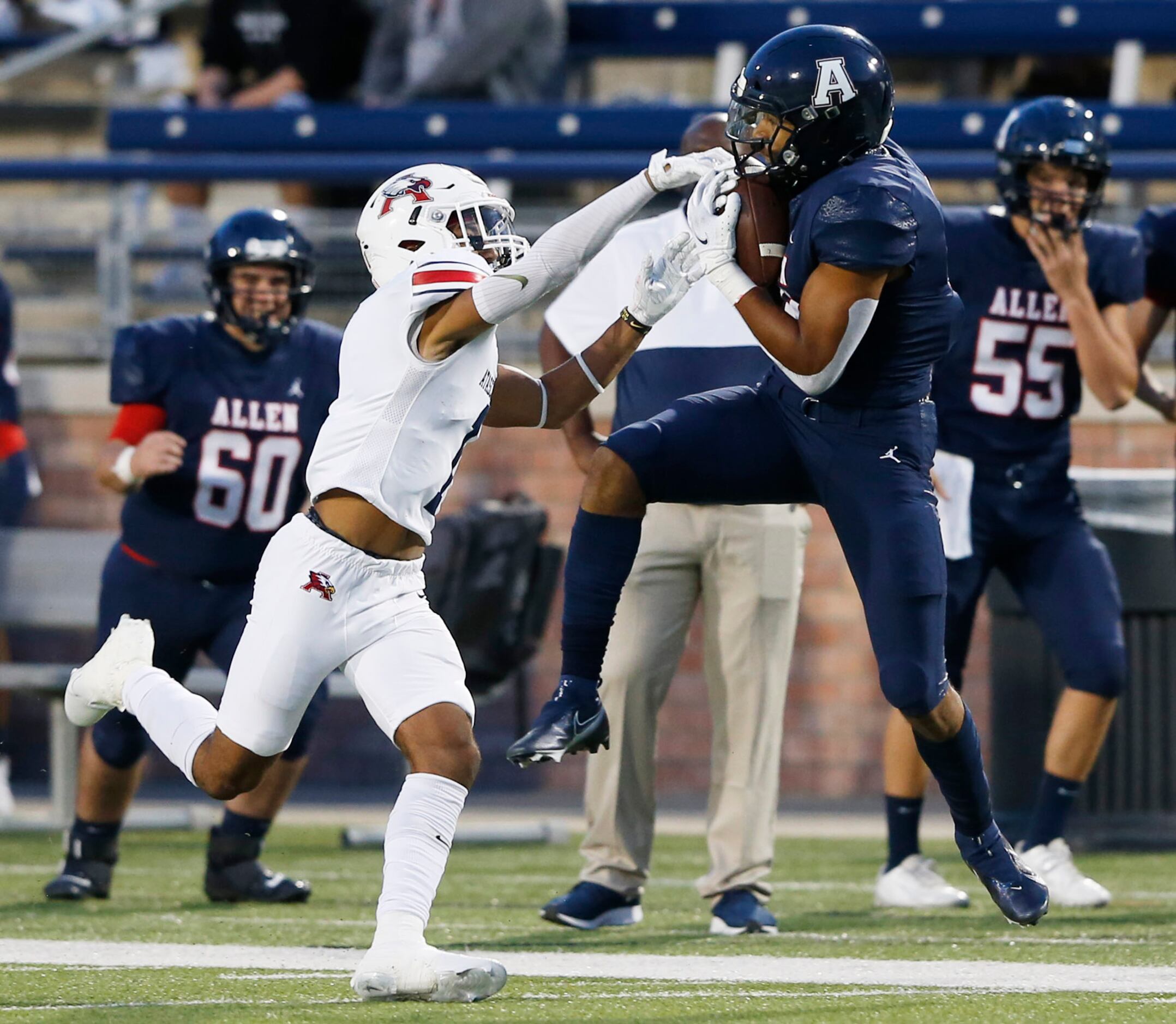 Allen's Bryson Green (9) catches a pass in front of Humble Atascocita's Jordan Augustine (1)...
