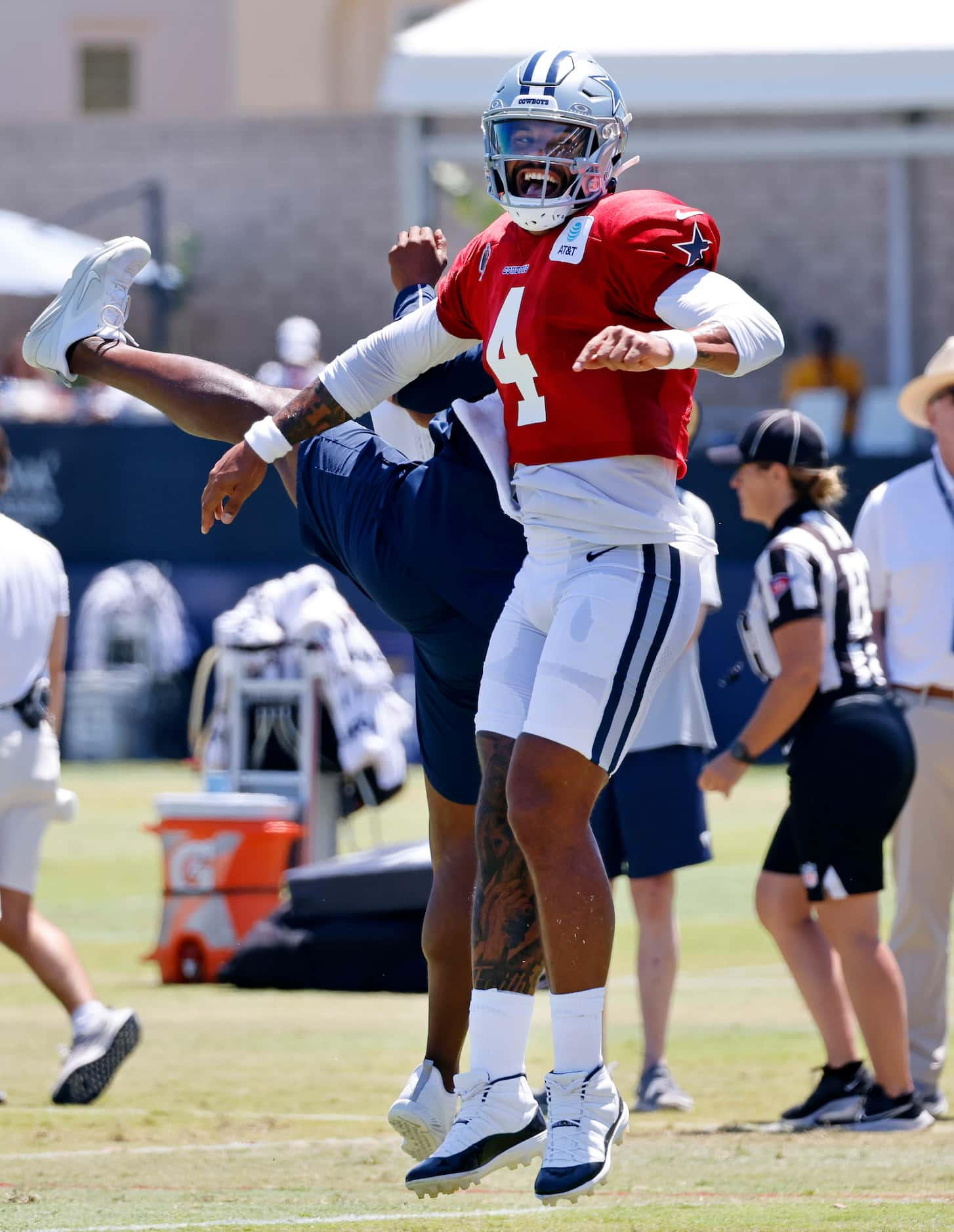 Dallas Cowboys quarterback Dak Prescott (4) and recievers coach Robert Prince after throwing...