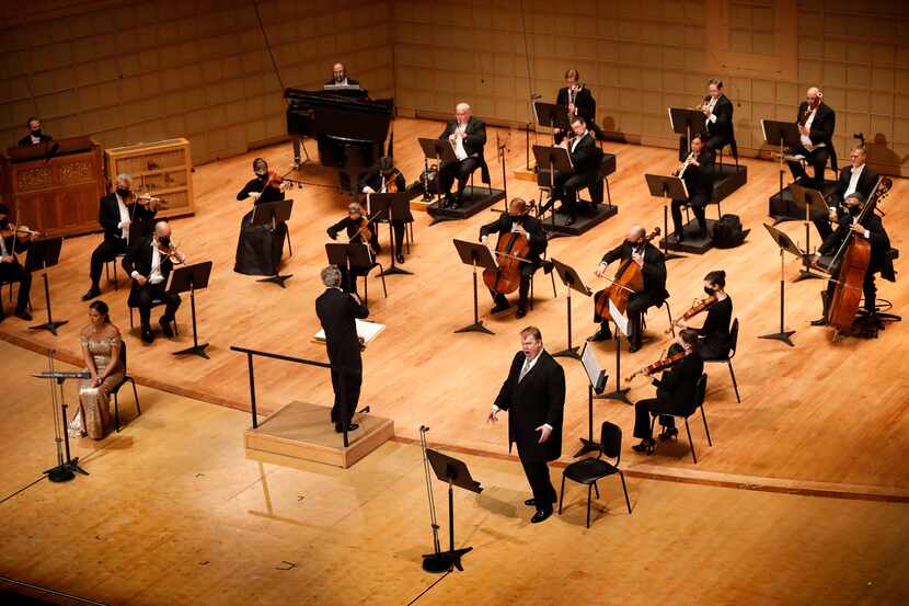 Music director Fabio Luisi (center) and his socially-distanced orchestra perform the...
