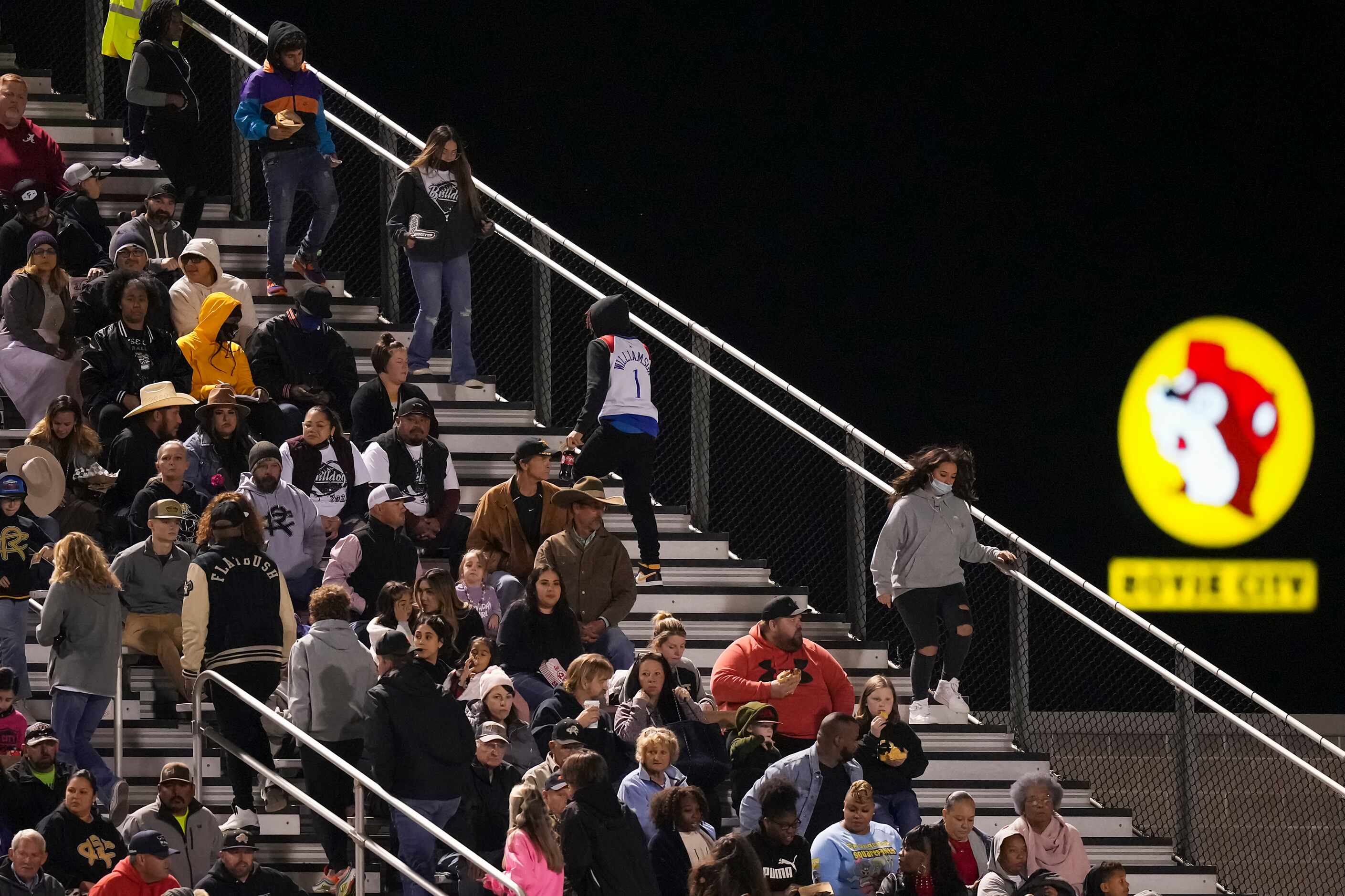 The sign for a nearby Buc-ee’s looms behind the stands as fans take their seats before a...
