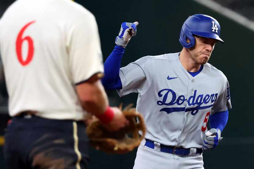 Los Angeles Dodgers' Freddie Freeman (5) pumps his fist as he runs the bases after a home...
