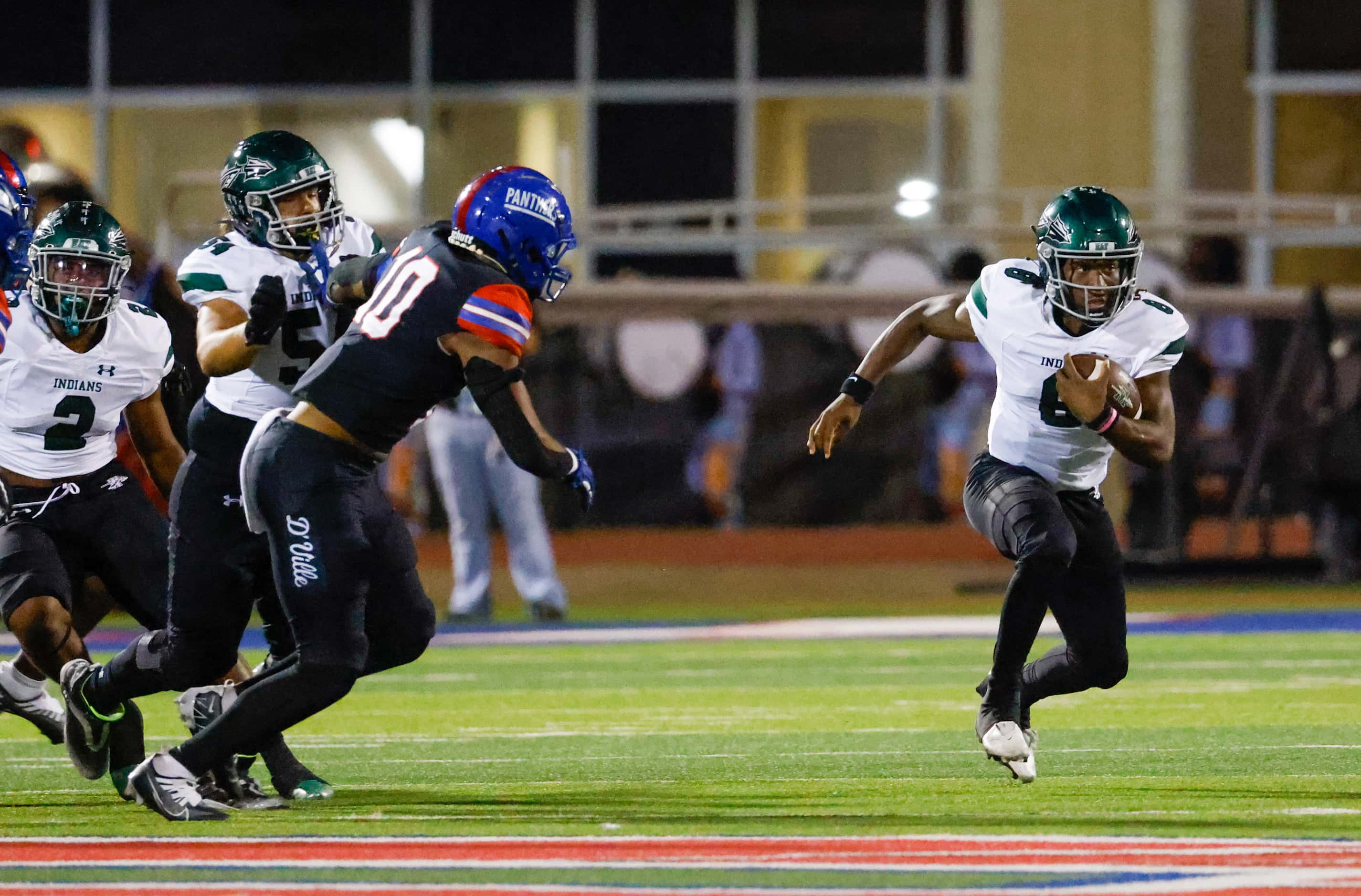 Waxahachie quarter back Ramon McKinney, Jr. (8) looks ahead as he carries the ball downfield...