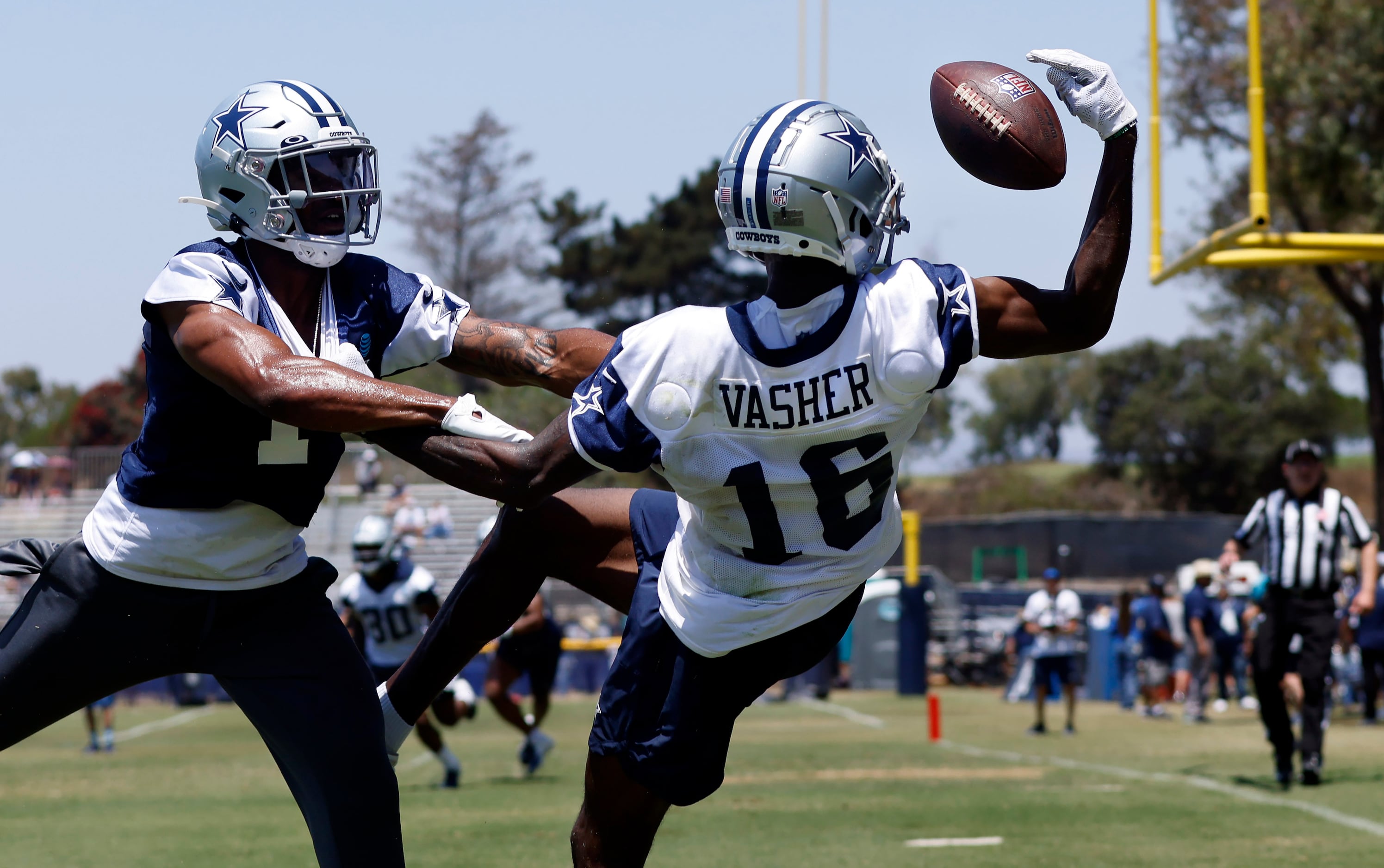 Dallas Cowboys wide receiver T.J. Vasher (16) makes a one-handed grab as he’s covered by...