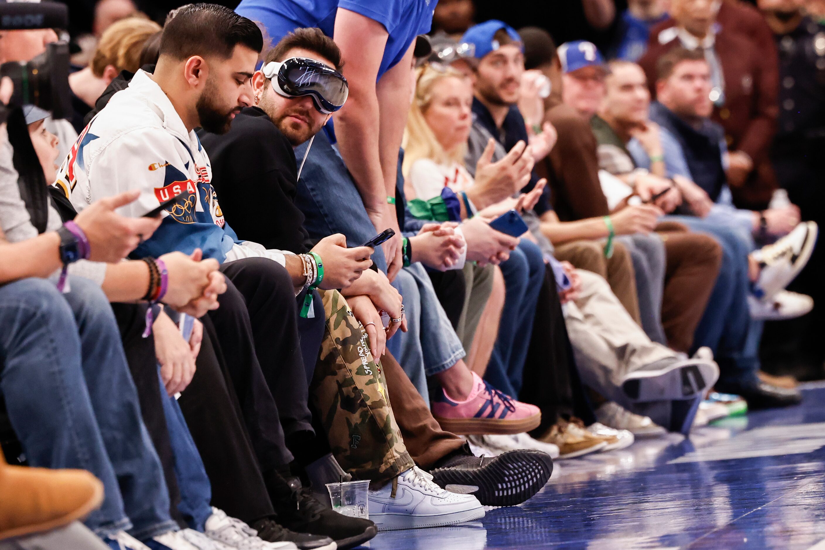 A court side spectator wears an Apple Vision Pro headset during the first half of an NBA...