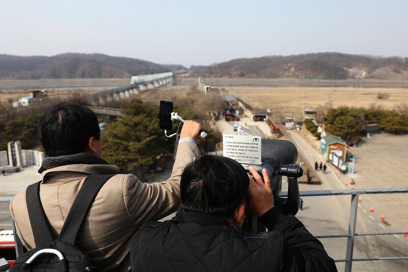 Visitors look toward North Korea at the Imjingak observation post near the demilitarized...