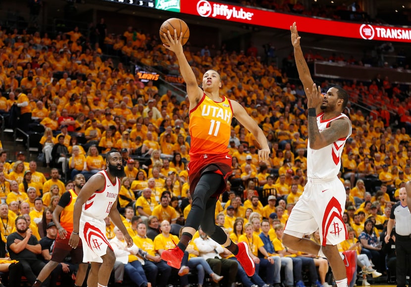 Utah Jazz guard Dante Exum (11) lays the ball up as Houston Rockets forward Trevor Ariza,...