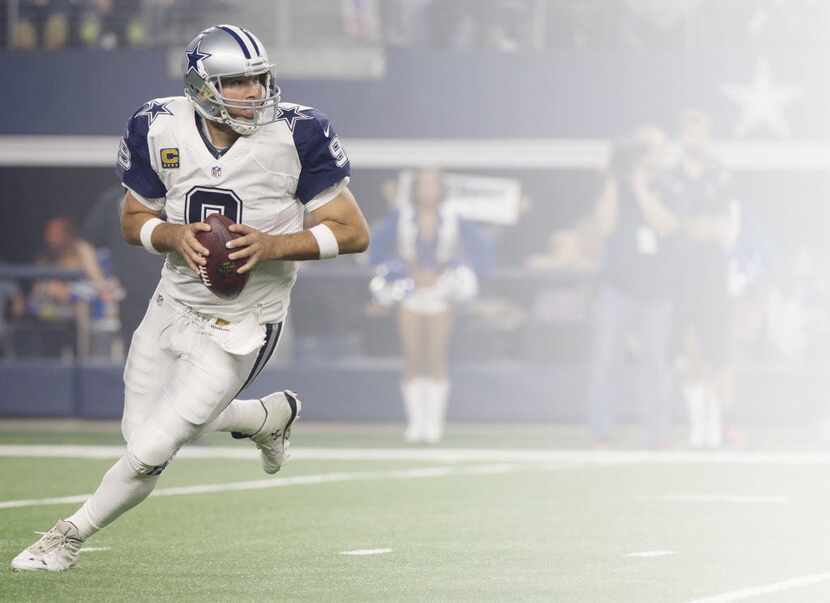 Nov 26, 2015; Arlington, TX, USA; Dallas Cowboys quarterback Tony Romo (9) rolls out to pass...