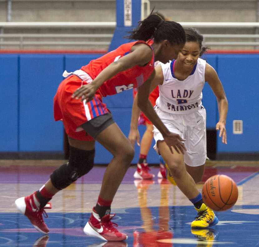 Garland Lakeview Centennial Lady Patriots guard Bre'Osha Scott (5) eyes a loose ball as does...