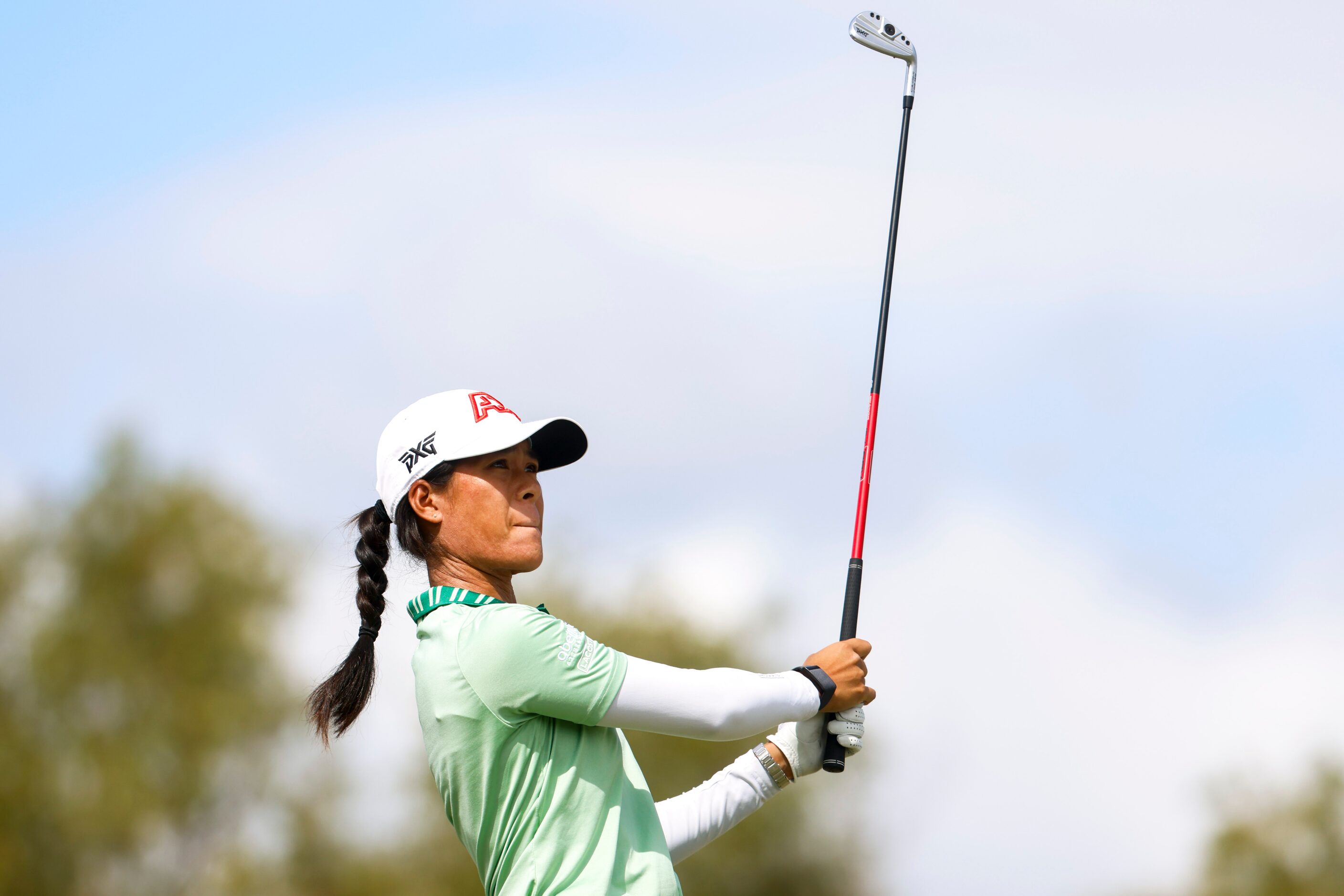 Celine Boutier of France watches as she hits on the 18th fairway during the first round of...