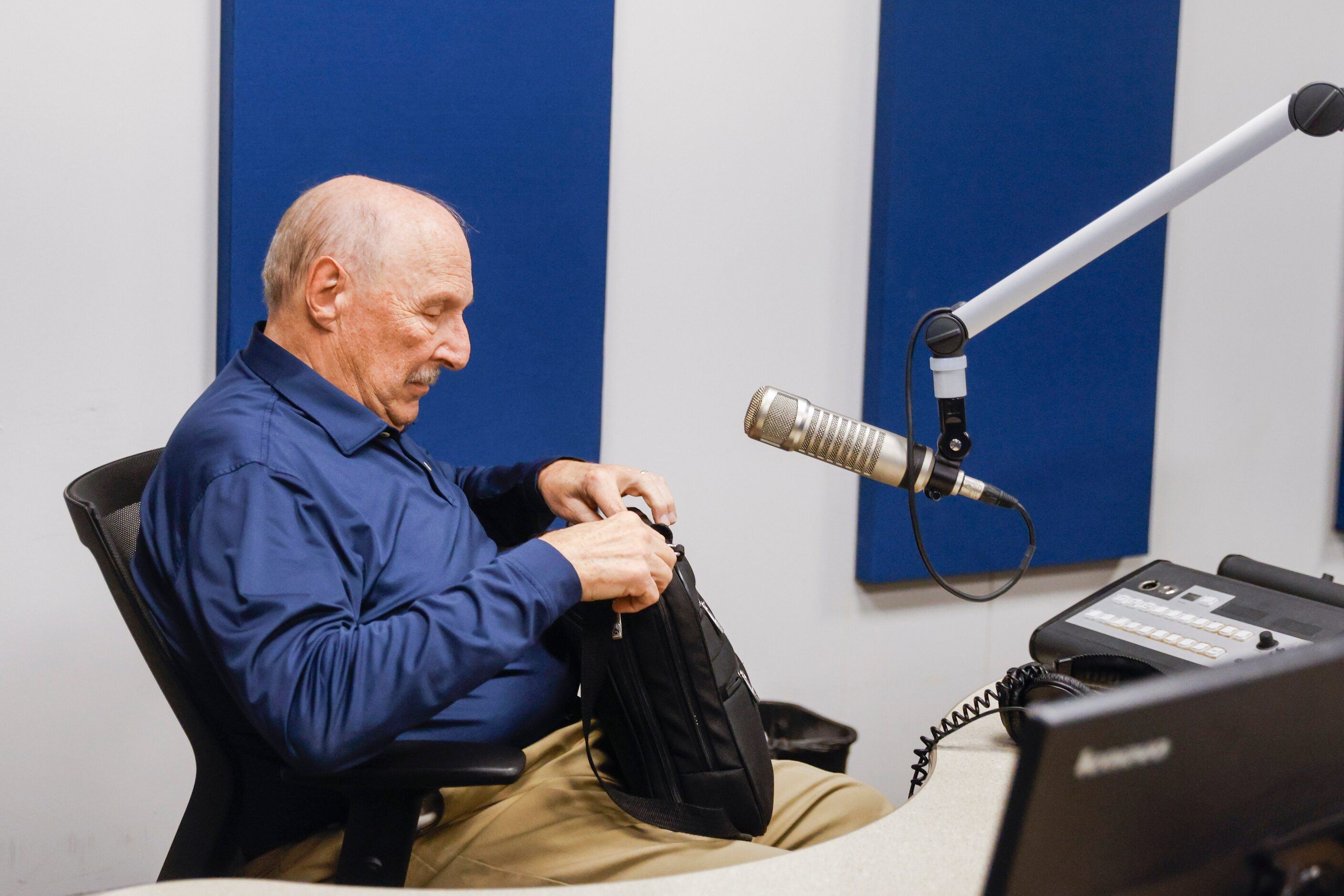 Local sports radio legend Norm Hitzges (left) packs his bag as he signs off for the last...