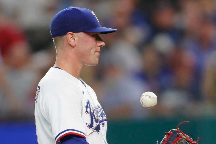 Texas Rangers pitcher Kolby Allard (39) tosses the ball in the air between batters during...