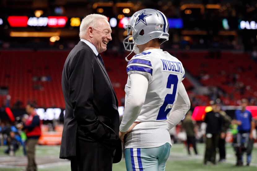 Dallas Cowboys kicker Mike Nugent (2) visits with owner Jerry Jones before their game with...