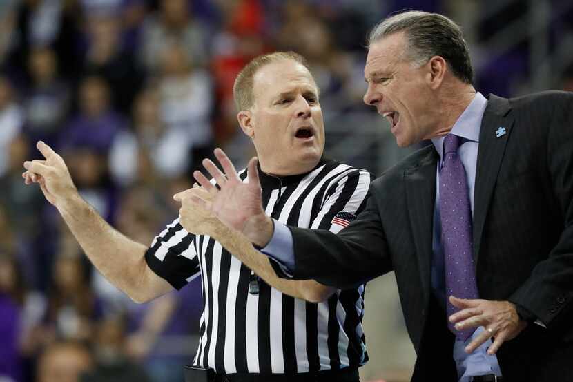 TCU head coach Jamie Dixon argues a call with official Gerry Pollard during the second half...