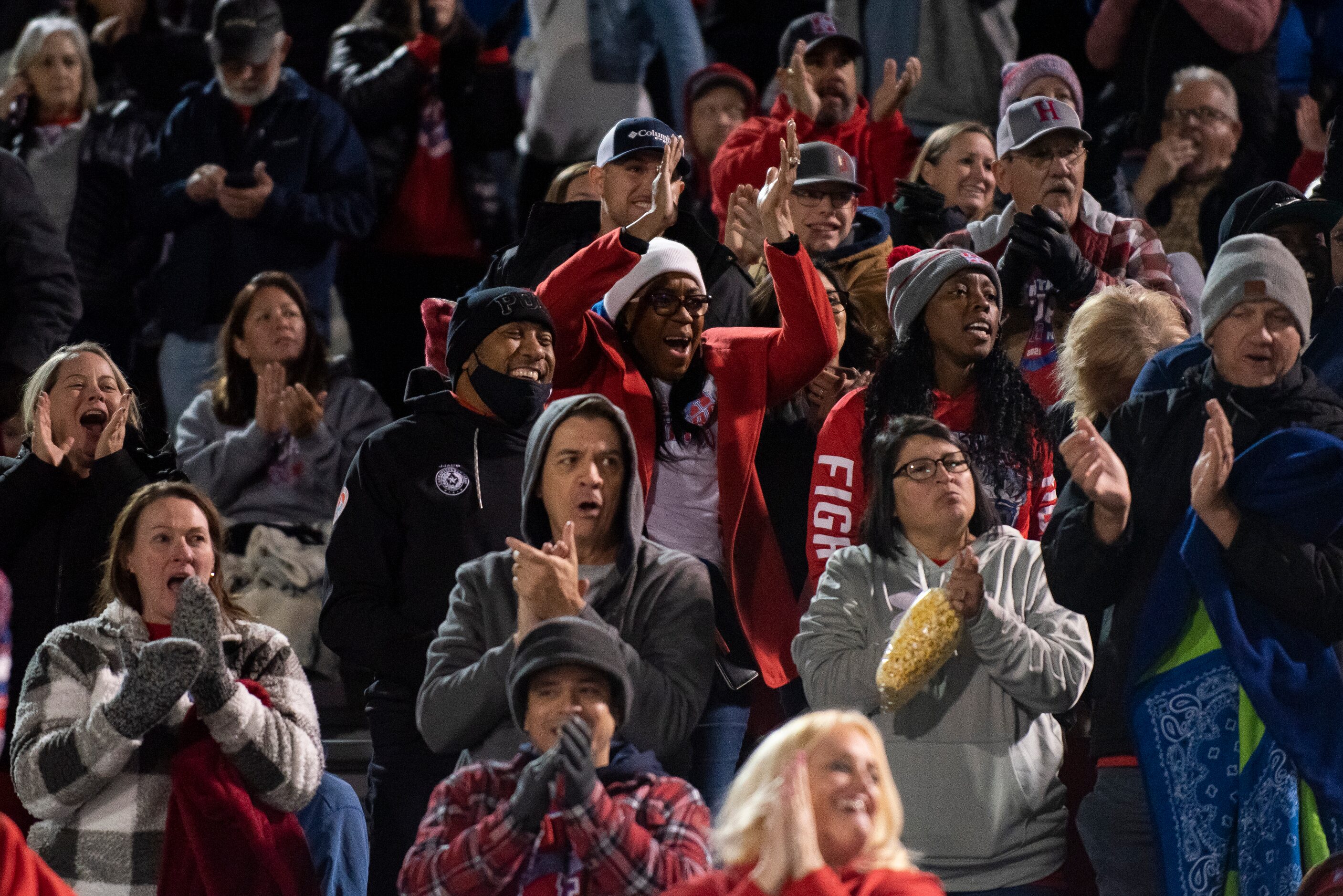 Midlothian Heritage fans cheer after their team scores a touchdown during the Class 4A...