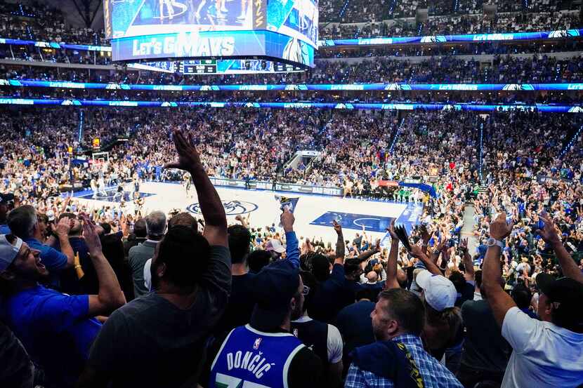 Dallas Mavericks fans celebrate a score during the first half in Game 3 of the NBA Finals...