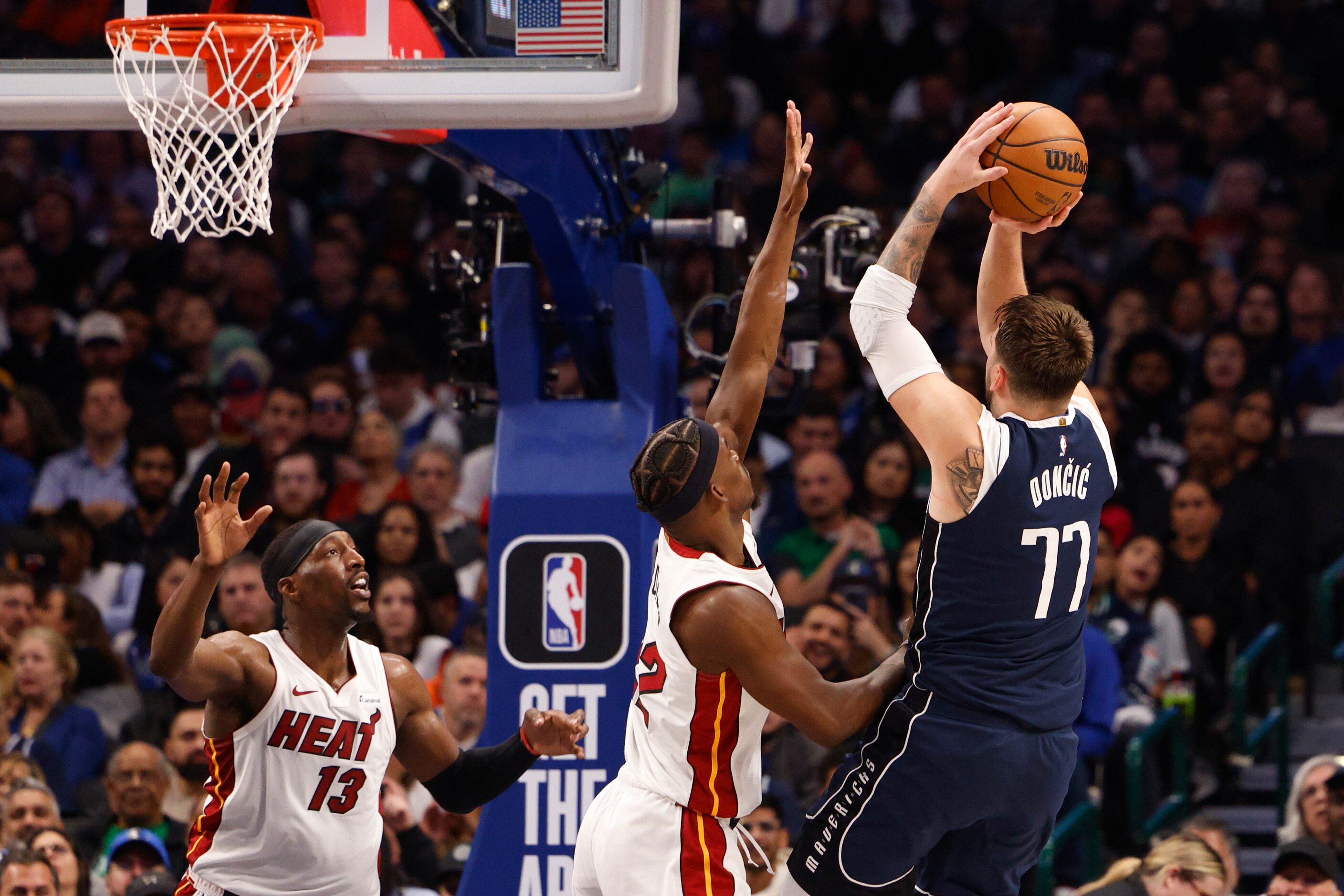 Dallas Mavericks guard Luka Doncic (77) shoots over Miami Heat forward Jimmy Butler (22)...