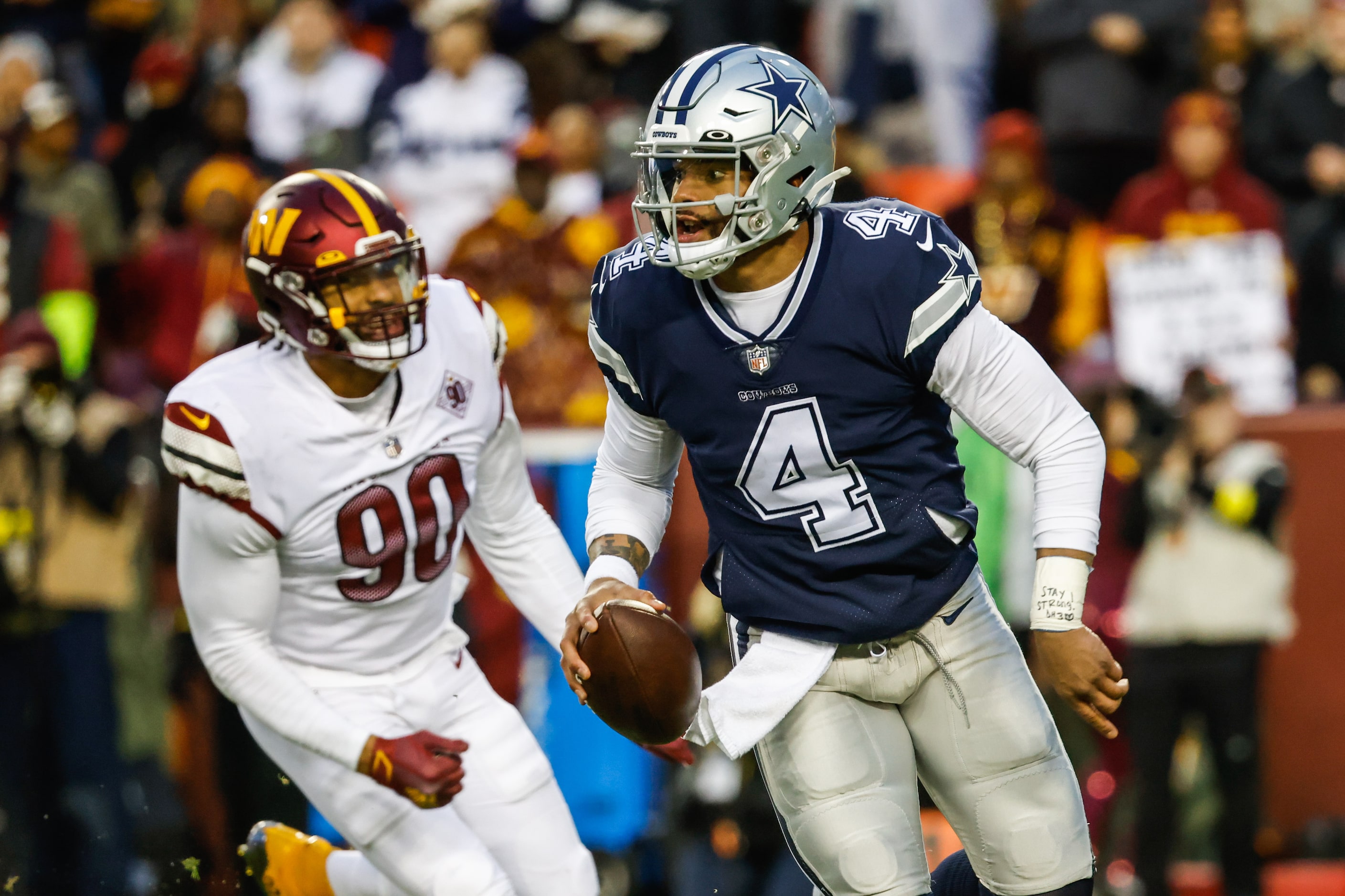 Dallas Cowboys quarterback Dak Prescott (4) runs with the football against Washington...