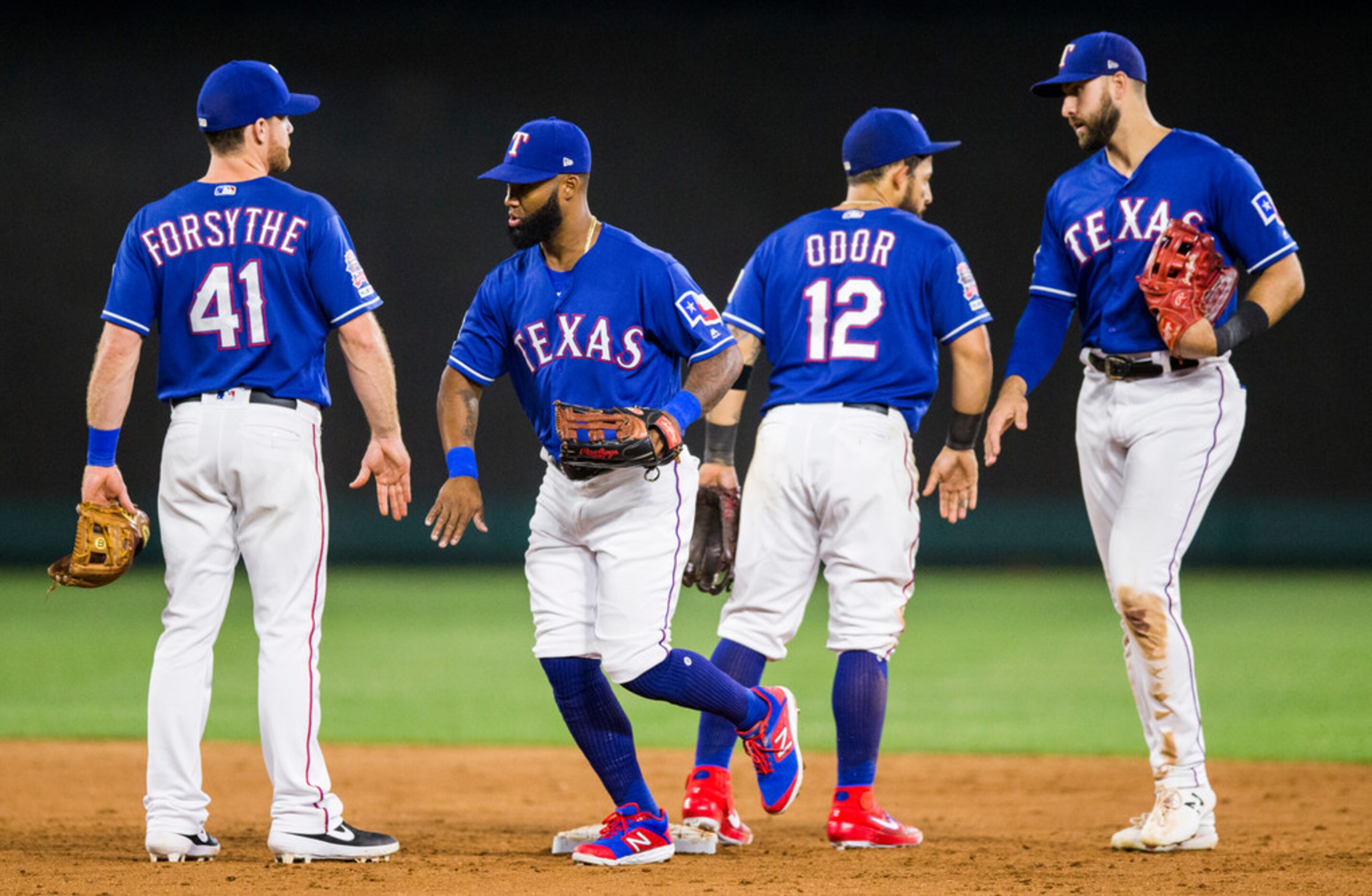 Texas Rangers celebrate a 5-3 walk off win over the Seattle Mariners on Tuesday, May 21,...