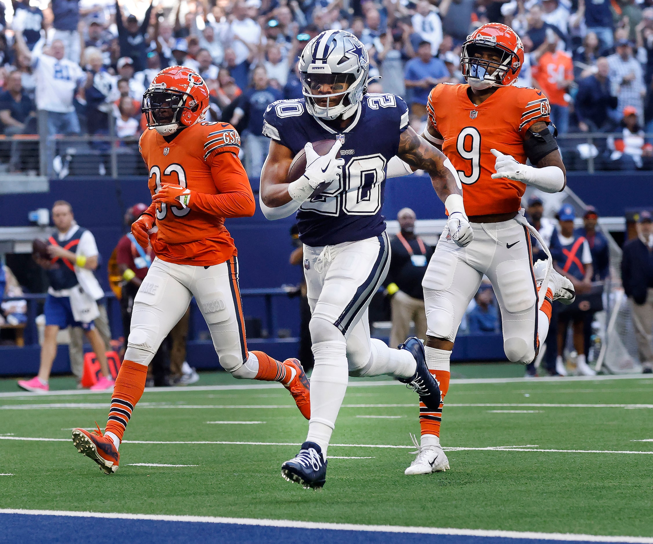 Dallas Cowboys running back Tony Pollard (20) outraces Chicago Bears safety Jaquan Brisker...