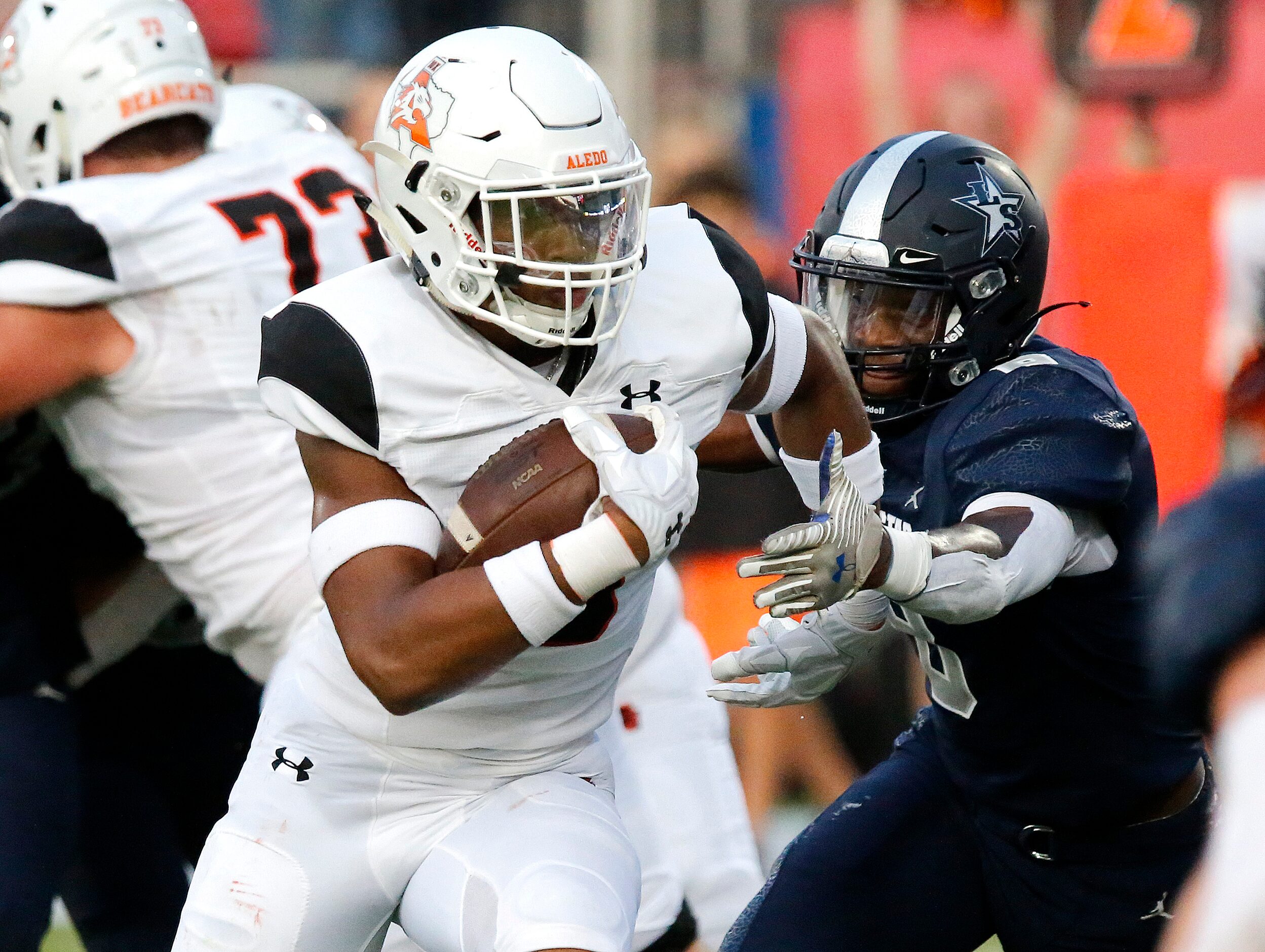 Aledo High School running back  Davhon Keys (3) runs from the grasp of Lone Star High School...