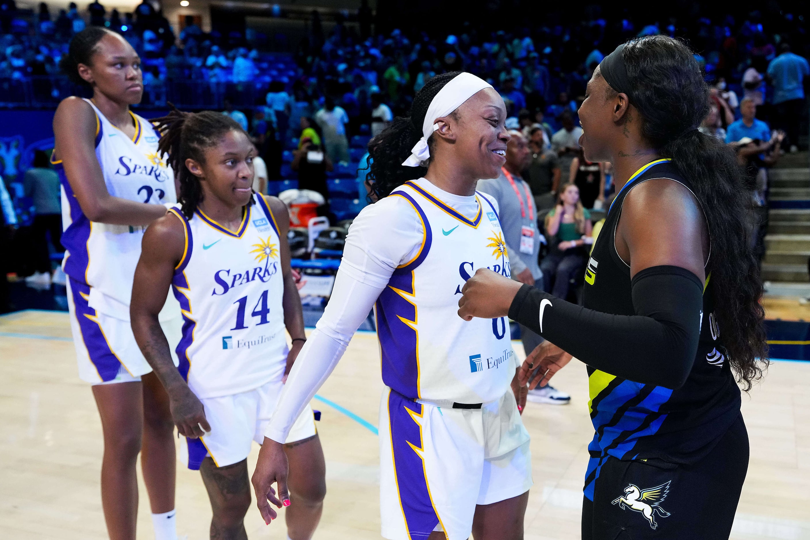 Los Angeles Sparks guard Odyssey Sims (6) hugs Dallas Wings guard Arike Ogunbowale (24)...