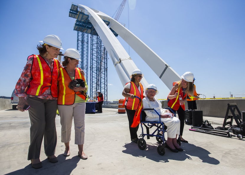 Margaret McDermott, second from right, is escorted on the Margaret McDermott Bridge, which...